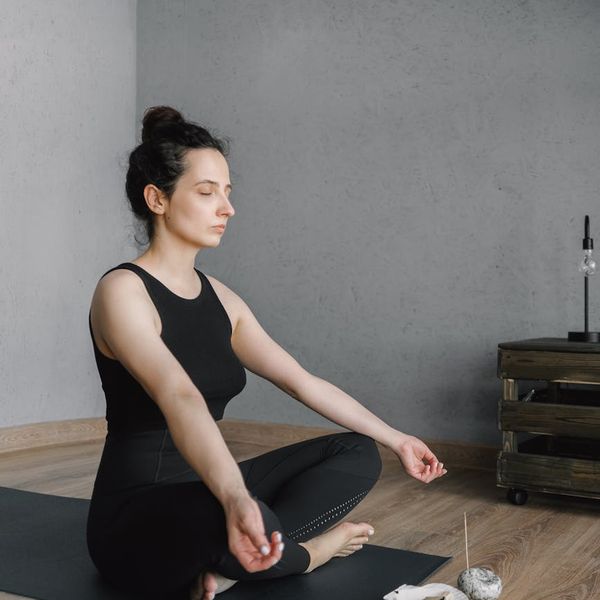 Woman meditating peacefully, representing peace of mind.